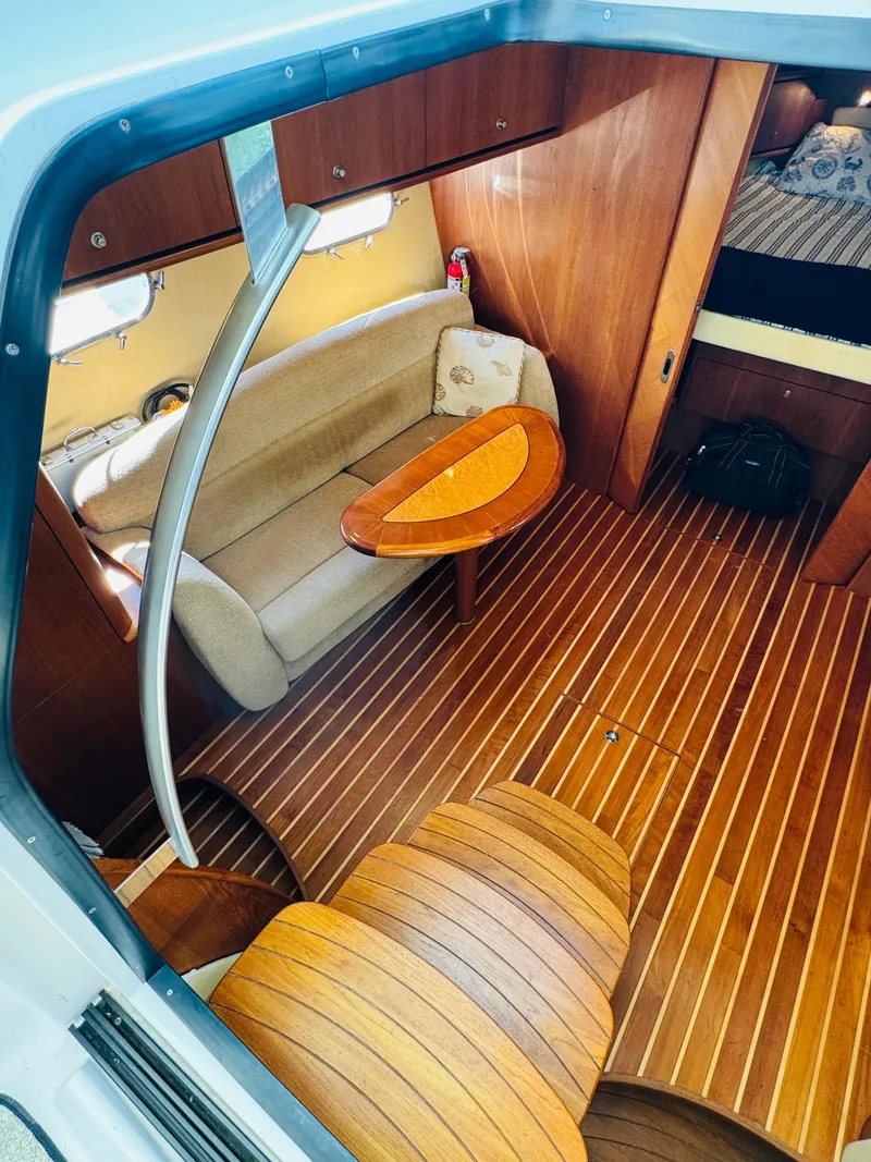 Slide: The Image of Interior of 2007 Tiara Yachts 3900 Sovran with wooden flooring and cozy seating area. - 15