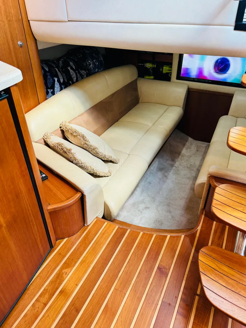 Slide: The Image of 2007 Tiara Yachts 3900 Sovran interior with beige leather seating and wooden flooring. - 16