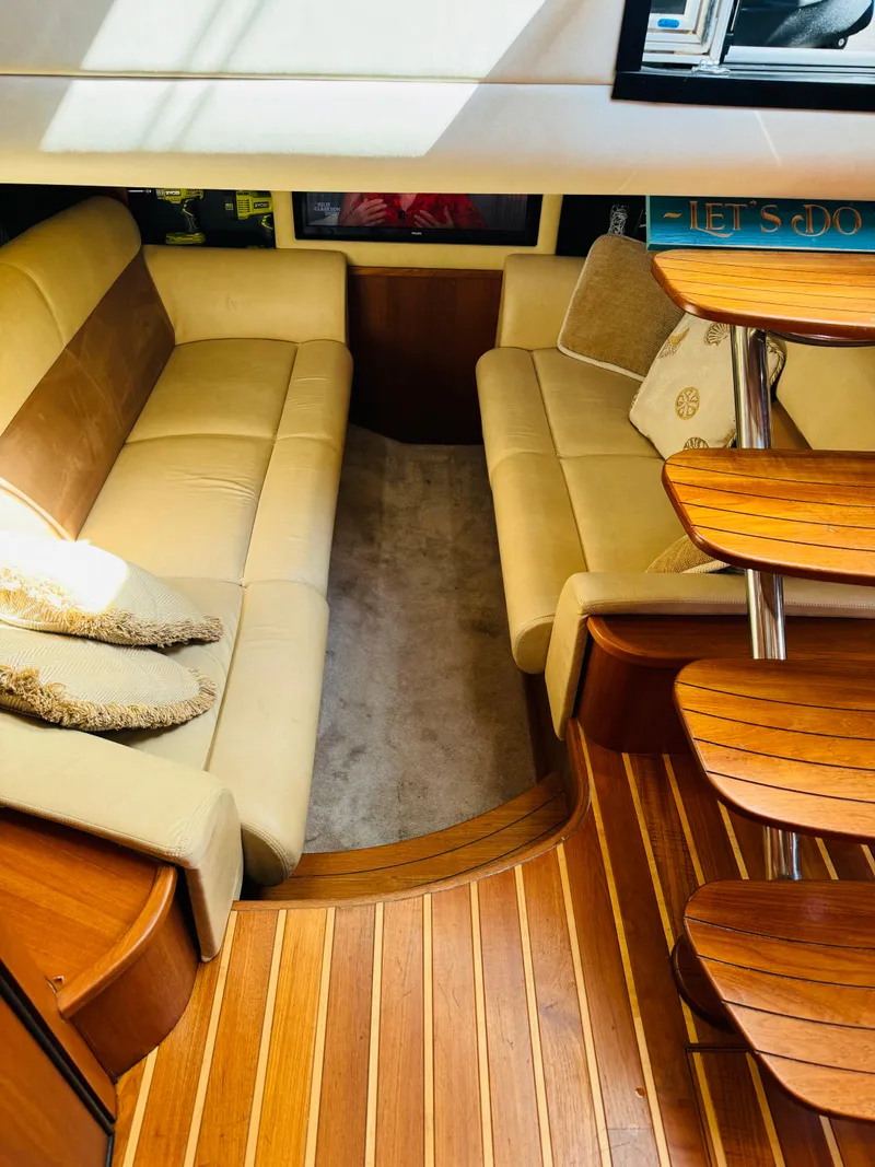 Slide: The Image of 2007 Tiara Yachts 3900 Sovran interior with beige seating and wooden flooring. - 18