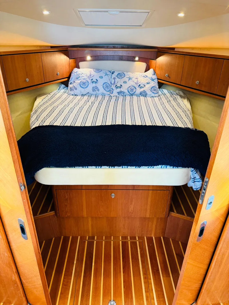 Slide: The Image of 2007 Tiara Yachts 3900 Sovran cabin with bed and wooden interior. - 2