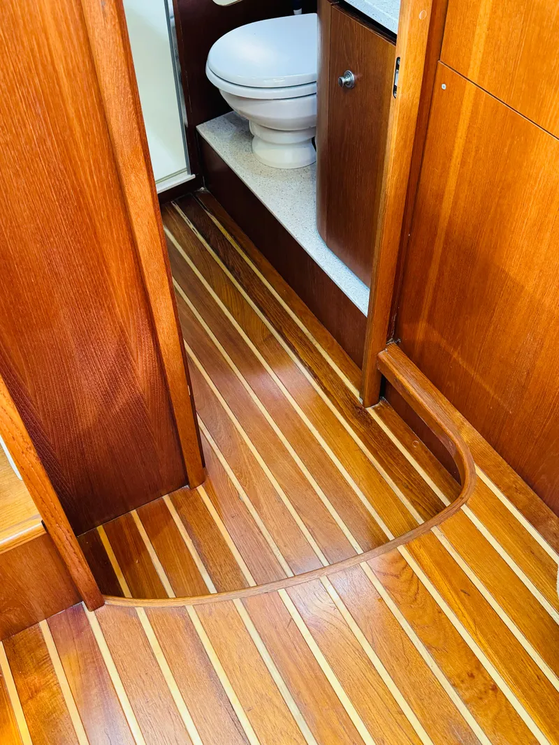 Slide: The Image of 2007 Tiara Yachts 3900 Sovran interior with wooden flooring and bathroom view. - 21