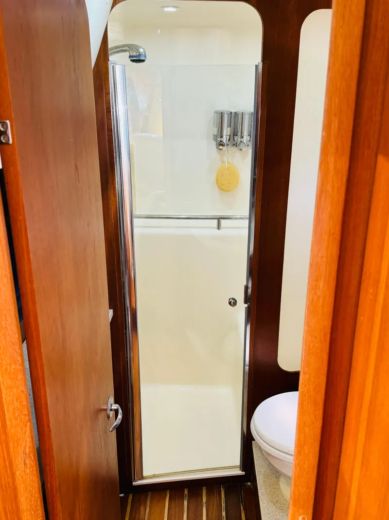 Slide: The Image of 2007 Tiara Yachts 3900 Sovran bathroom with shower and wooden accents. - 23