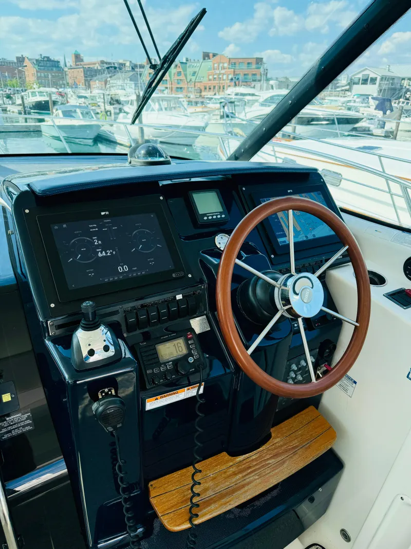 Slide: The Image of 2007 Tiara Yachts 3900 Sovran helm with modern navigation equipment and wooden steering wheel. - 25