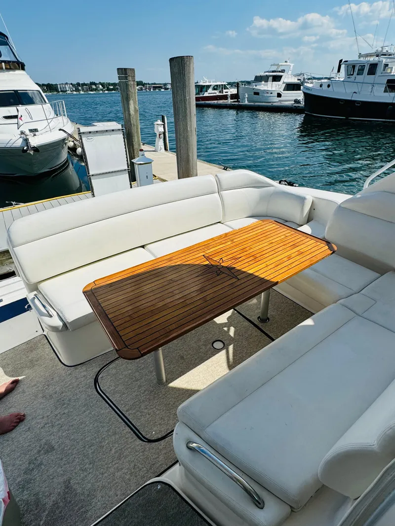 Slide: The Image of 2007 Tiara Yachts 3900 Sovran with teak table and white seating at the dock. - 33