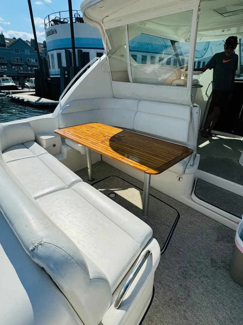 Slide: The Image of 2007 Tiara Yachts 3900 Sovran with spacious outdoor seating and wooden table. - 34