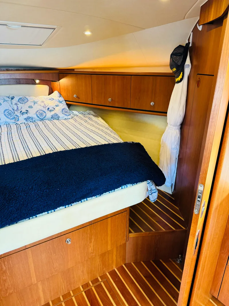 Slide: The Image of 2007 Tiara Yachts 3900 Sovran cabin interior with bed and wooden cabinetry. - 4