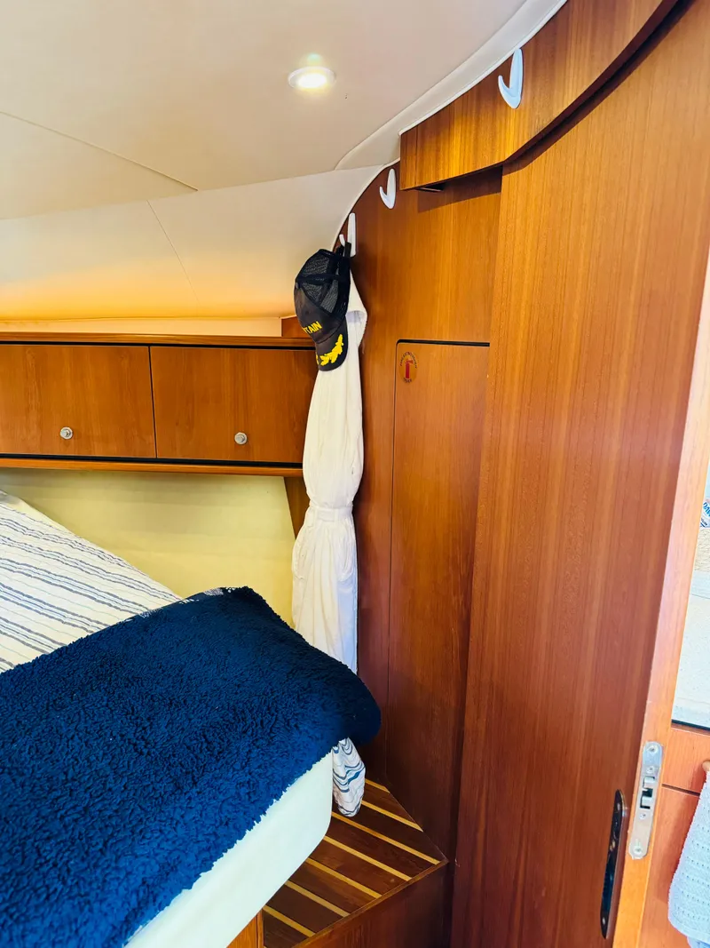 Slide: The Image of 2007 Tiara Yachts 3900 Sovran cabin interior with wooden cabinetry and bed. - 6