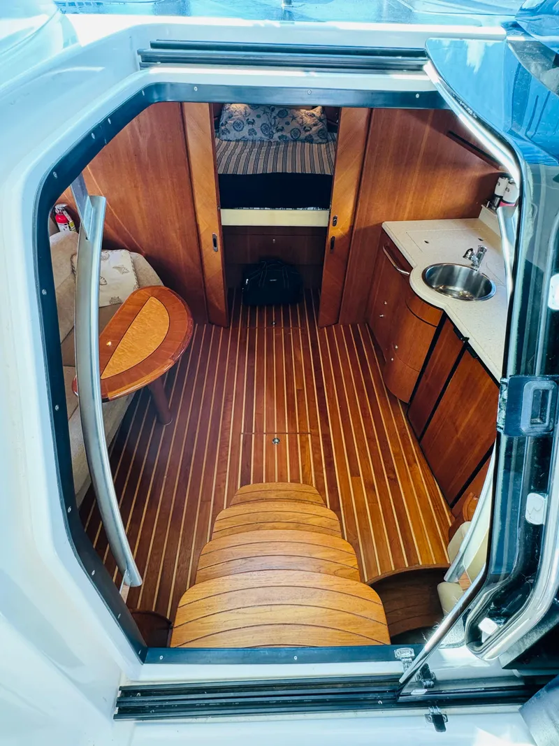 Slide: The Image of 2007 Tiara Yachts 3900 Sovran interior cabin with wood flooring and kitchenette. - 8