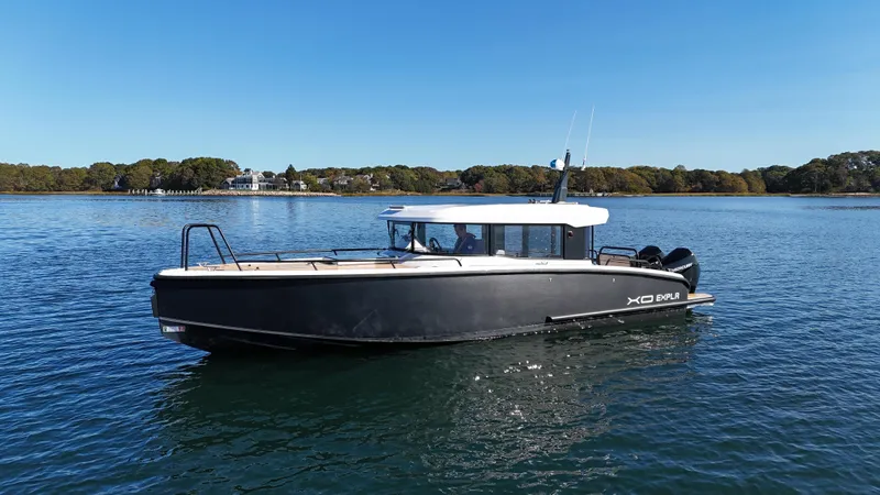 Slide: The Image of 2023 XO Boats EXPLR 10 Sport Plus on calm water, showcasing sleek design. - 0