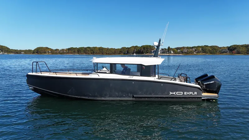 Slide: The Image of 2023 XO Boats EXPLR 10 Sport Plus on calm water, side view. - 1