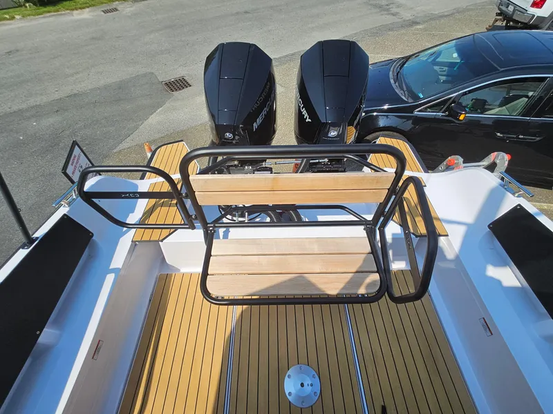 Slide: The Image of 2023 XO Boats EXPLR 10 Sport Plus with twin Mercury outboard engines, rear deck view. - 10