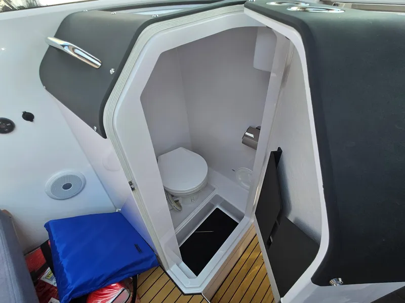 Slide: The Image of 2023 XO Boats EXPLR 10 Sport Plus interior bathroom with toilet and modern design. - 13