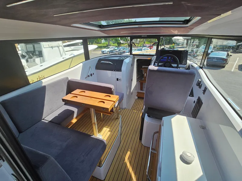 Slide: The Image of Interior of 2023 XO Boats EXPLR 10 Sport Plus, featuring seating and helm station. - 15