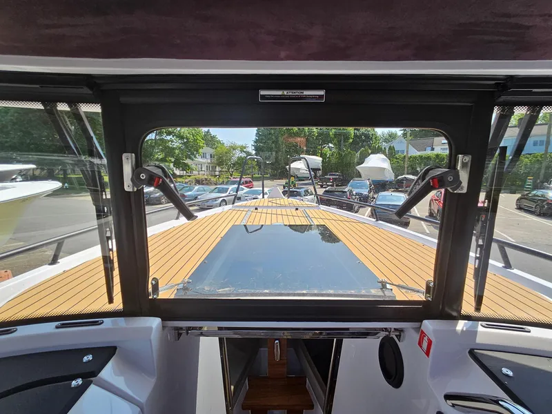 Slide: The Image of 2023 XO Boats EXPLR 10 Sport Plus cockpit view with teak deck and windshield. - 20