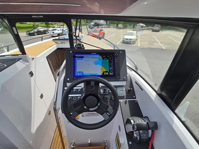 Slide: The Image of 2023 XO Boats EXPLR 10 Sport Plus dashboard with navigation screen and steering wheel. - 28