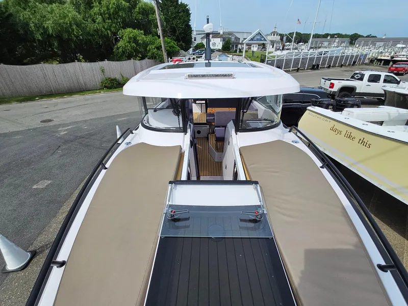Slide: The Image of 2023 XO Boats EXPLR 10 Sport Plus docked, showcasing spacious deck and modern design. - 29