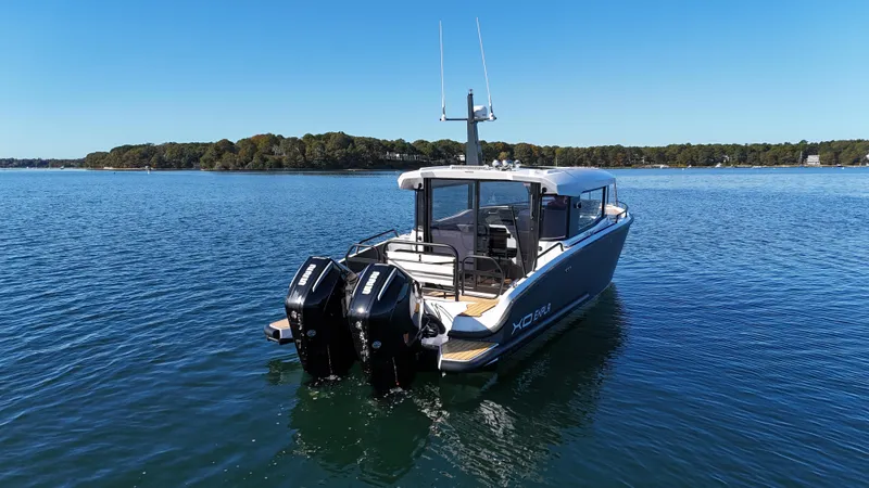 Slide: The Image of 2023 XO Boats EXPLR 10 Sport Plus on calm water, rear view. - 5