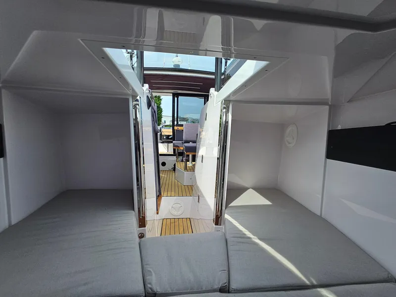 Slide: The Image of 2023 XO Boats EXPLR 10 Sport Plus cabin interior with open hatch and seating. - 25