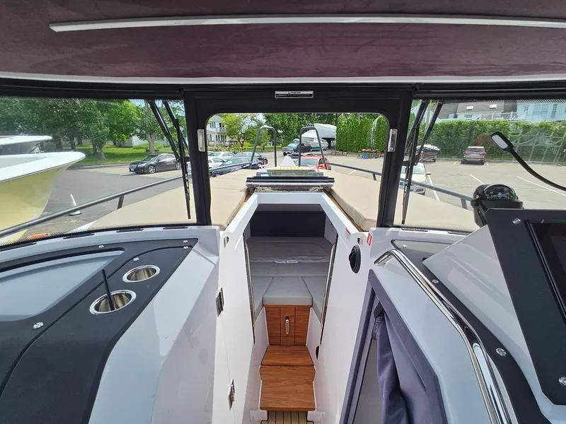 Slide: The Image of 2023 XO Boats EXPLR 10 Sport Plus interior view with seating and dashboard. - 27