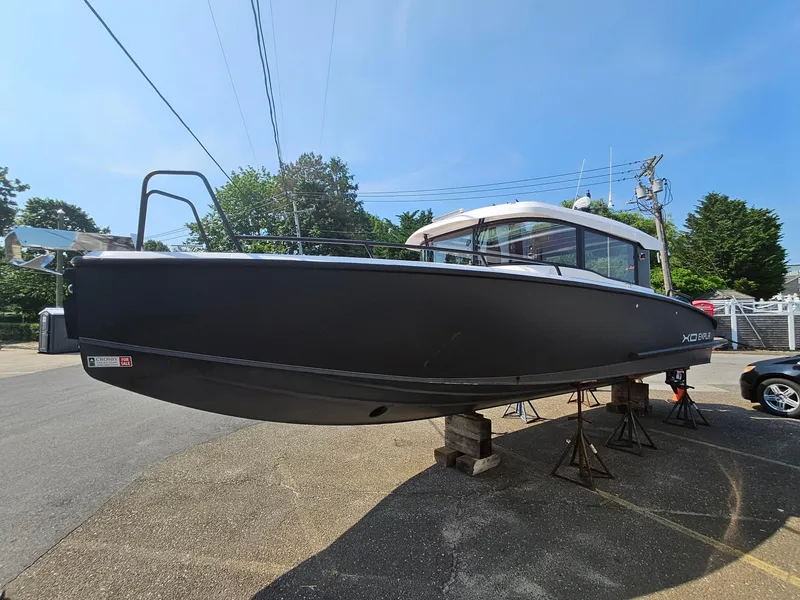Slide: The Image of 2023 XO Boats EXPLR 10 Sport Plus on stands, side view, outdoors. - 7