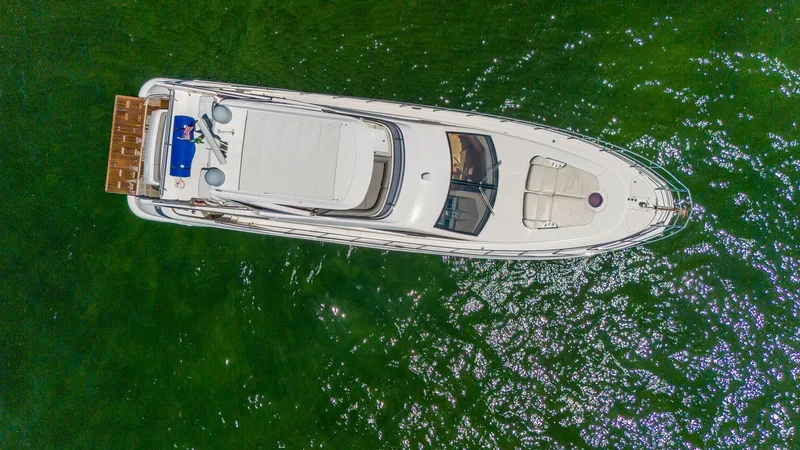 Slide: The Image of Aerial view of 2013 Azimut 64 Fly yacht on green water. - 2