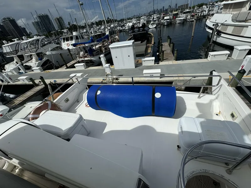 Slide: The Image of 2013 Azimut 64 Fly yacht docked at a marina with blue barrel on deck. - 31