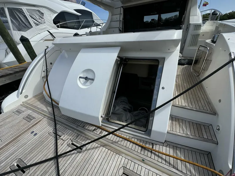 Slide: The Image of 2013 Azimut 64 Fly yacht with open hatch and wooden deck. - 32