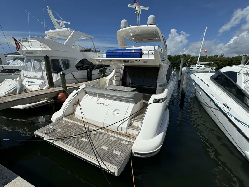 Slide: The Image of 2013 Azimut 64 Fly yacht docked at a marina, rear view. - 6