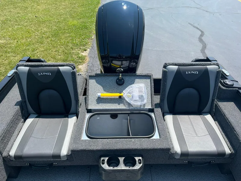 Slide: The Image of 2025 Lund 1675 Adventure Sport boat interior with two seats and storage compartment. - 12