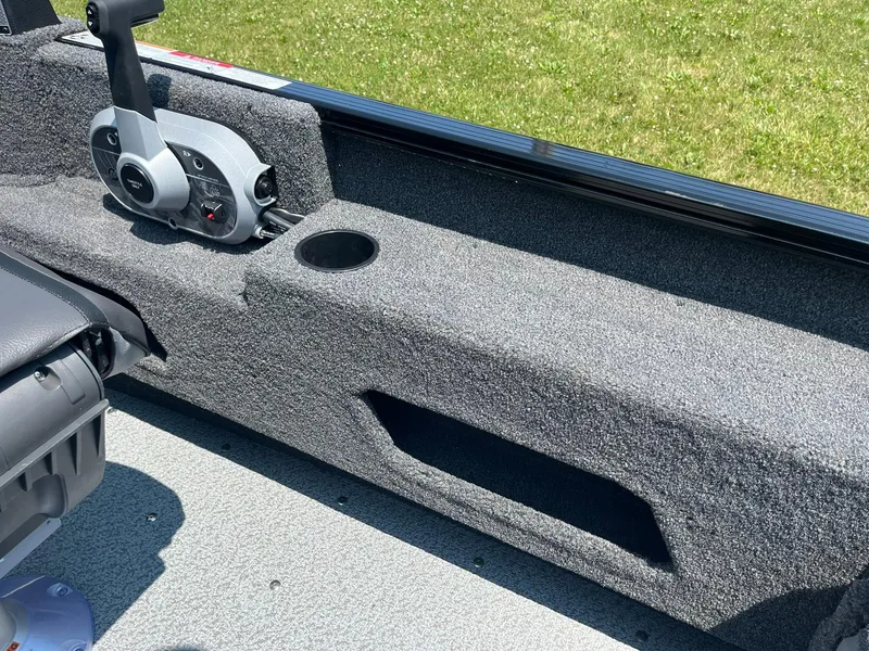 Slide: The Image of 2025 Lund 1675 Adventure Sport boat interior with control panel and cup holder. - 13