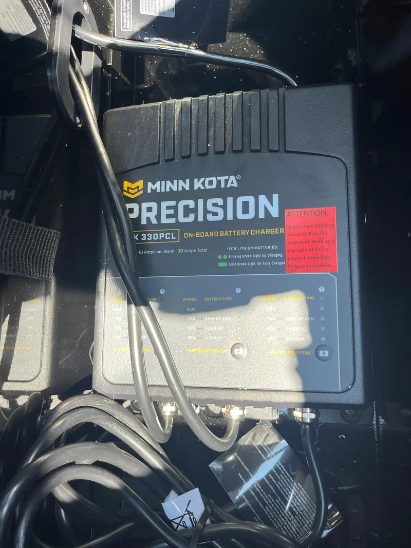 Slide: The Image of Minn Kota Precision on-board battery charger in a 2025 Lund 1675 Adventure Sport boat. - 16
