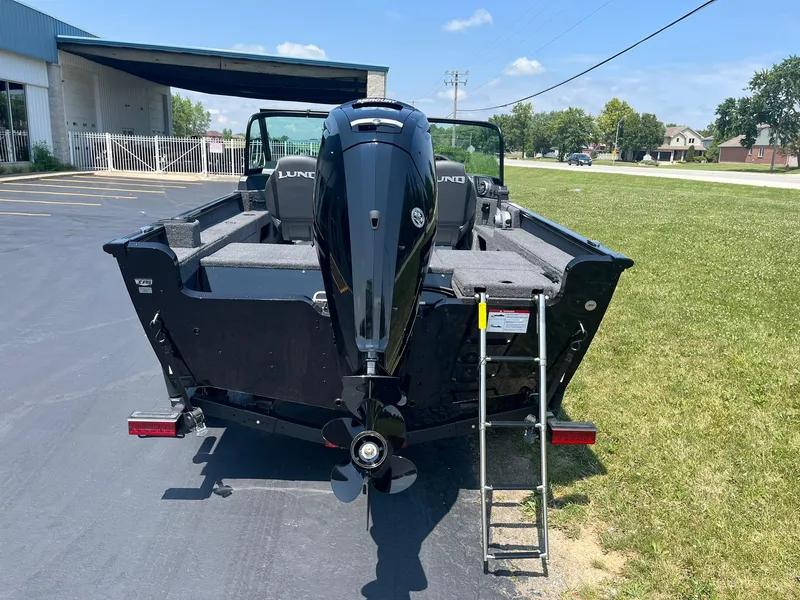 Slide: The Image of 2025 Lund 1675 Adventure Sport boat with outboard motor and ladder. - 2