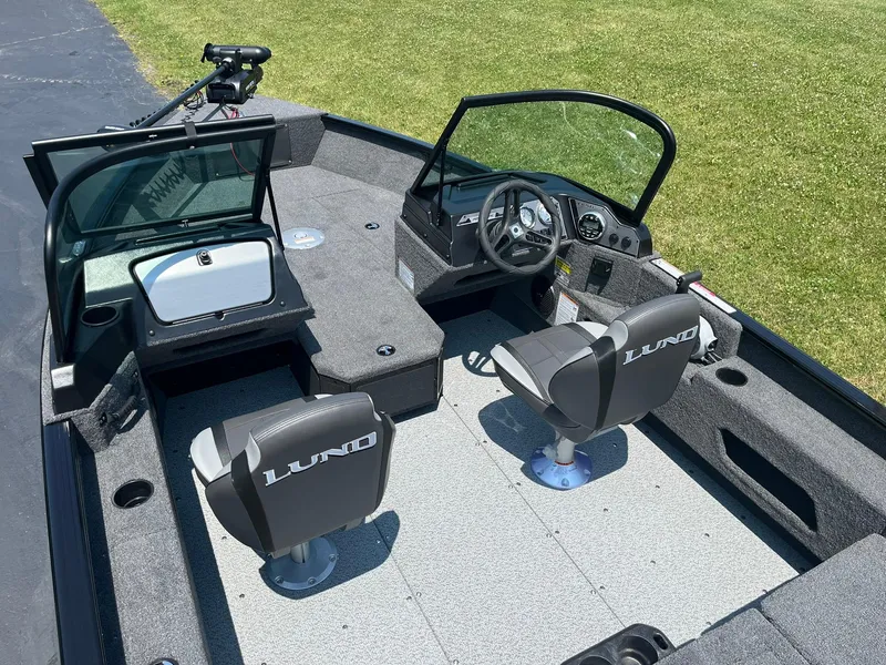Slide: The Image of 2025 Lund 1675 Adventure Sport boat interior with two seats and steering console. - 5