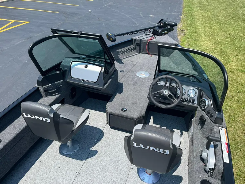 Slide: The Image of 2025 Lund 1675 Adventure Sport boat interior with dual seats and control console. - 6