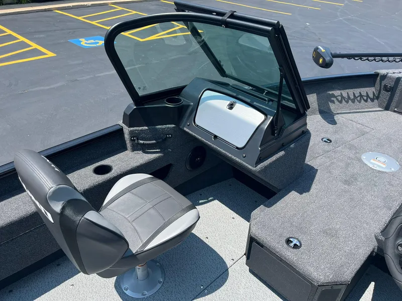 Slide: The Image of 2025 Lund 1675 Adventure Sport boat interior with captain's chair and dashboard. - 7