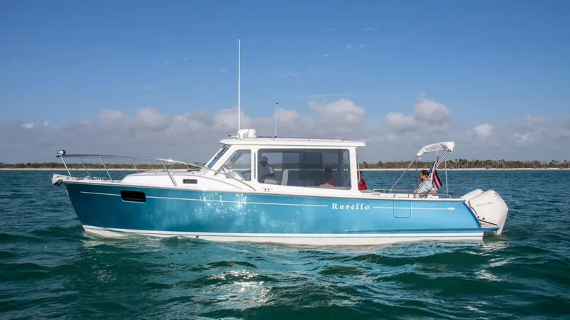 Slide: The Image of 2025 MJM 35 boat cruising on open water under a clear sky. - 0