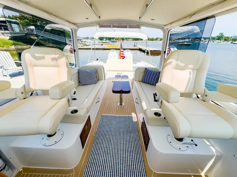 Slide: The Image of MJM 35 2025 model boat interior with luxurious seating and scenic water view. - 11