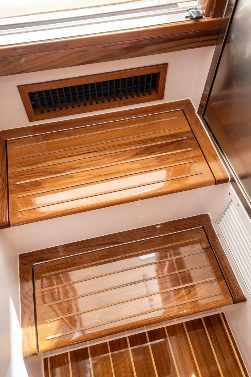 Slide: The Image of 2025 MJM 35 yacht interior with polished wooden steps and vent. - 15