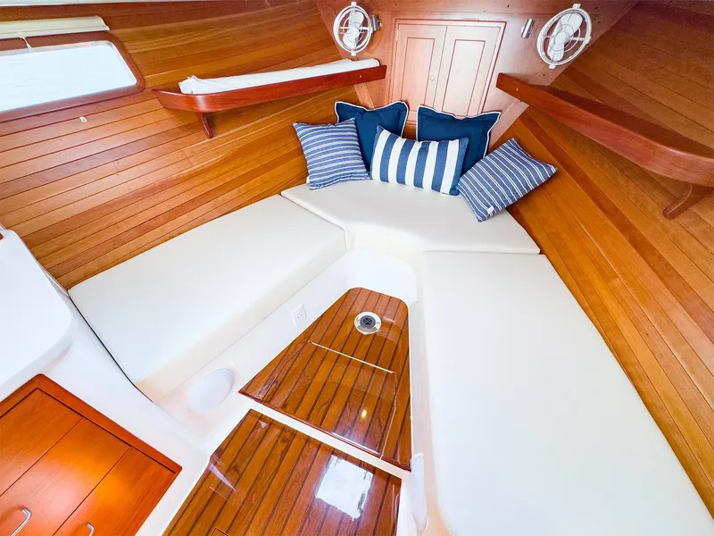 Slide: The Image of MJM 35 2025 model boat interior with cozy seating and striped cushions. - 19