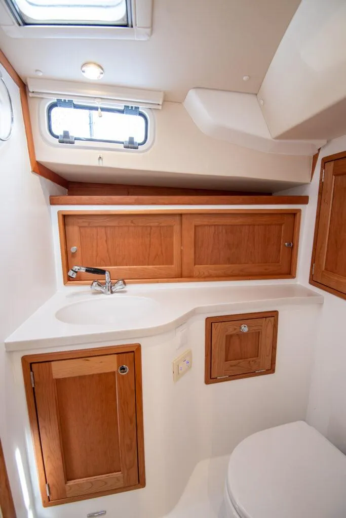 Slide: The Image of 2025 MJM 35 boat bathroom with wooden cabinets and modern fixtures. - 2