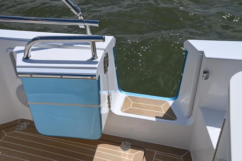 Slide: The Image of MJM 35 boat, 2025 model, open transom door with teak flooring, near water. - 20