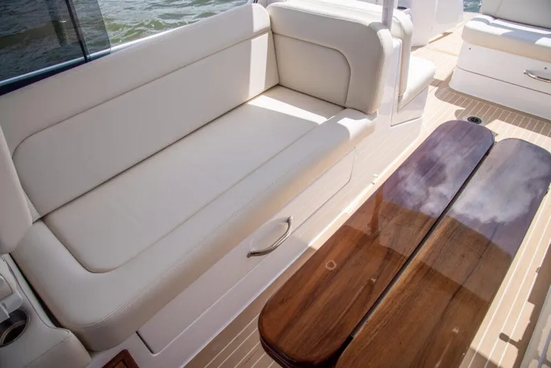 Slide: The Image of Luxurious seating area on the 2025 MJM 35 boat with a polished wooden table. - 37