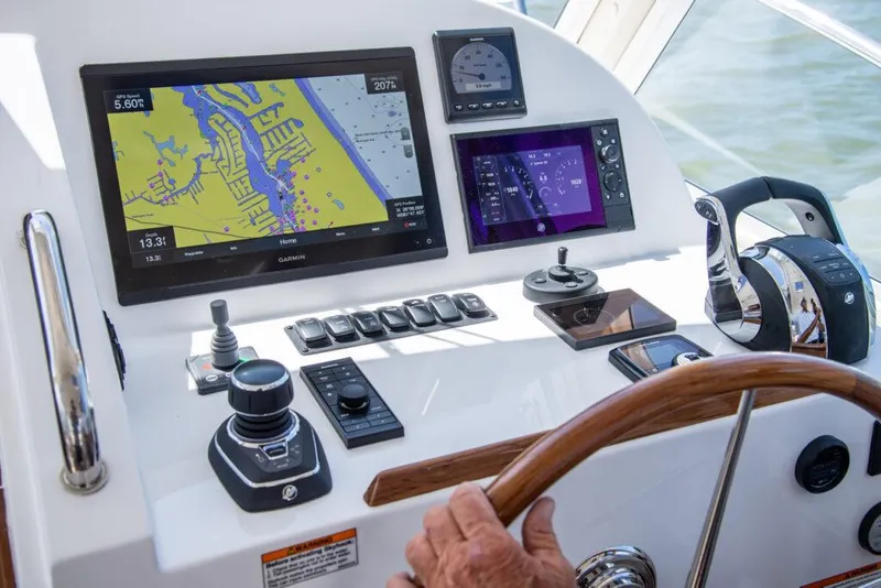 Slide: The Image of MJM 35 boat dashboard with navigation screens and controls, 2025 model. - 5