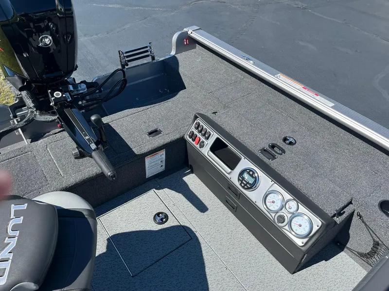 Slide: The Image of 2025 Lund 1875 Pro Guide boat interior with control panel and motor. - 12