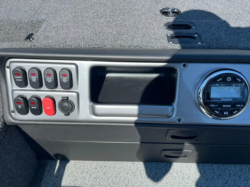 Slide: The Image of Control panel of 2025 Lund 1875 Pro Guide boat with switches and stereo system. - 14