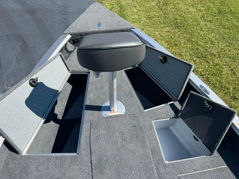 Slide: The Image of 2025 Lund 1875 Pro Guide boat with open storage compartments and a seat. - 17