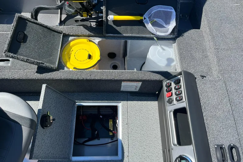 Slide: The Image of 2025 Lund 1875 Pro Guide boat interior with storage compartments and fishing gear. - 25