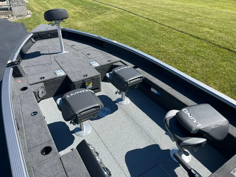 Slide: The Image of 2025 Lund 1875 Pro Guide fishing boat interior with seating and storage compartments. - 7
