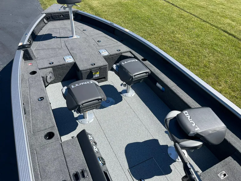 Slide: The Image of 2025 Lund 1875 Pro Guide fishing boat interior with seating and storage compartments. - 8