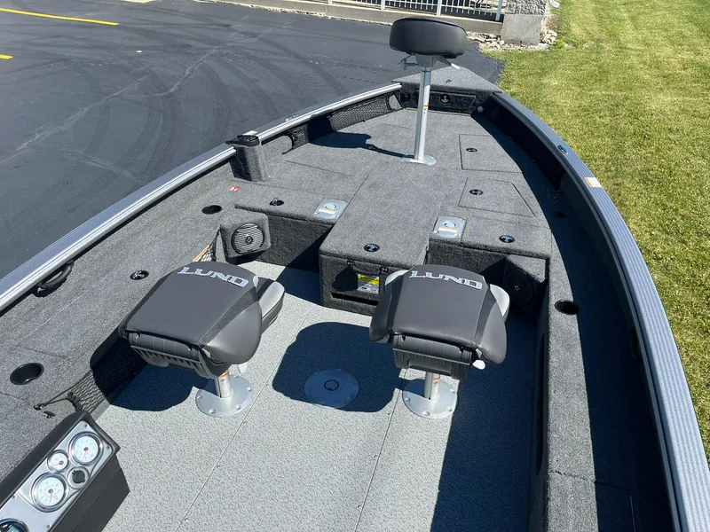 Slide: The Image of 2025 Lund 1875 Pro Guide fishing boat interior with seating and storage compartments. - 9